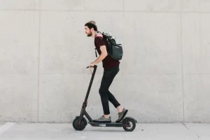 sideways-man-riding-e-scooter